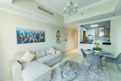 a living room with a couch and a table at Dunya Tower 1BR Heart of Dubai Downtown in Dubai