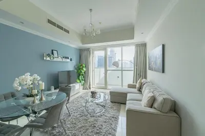 a living room with a couch and a table at Dunya Tower 1BR Heart of Dubai Downtown in Dubai