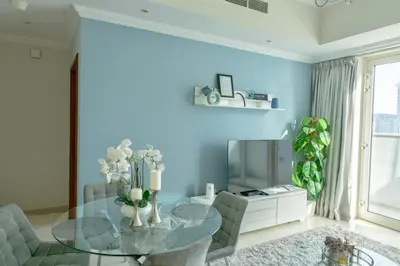 a dining room with a glass table and chairs at Dunya Tower 1BR Heart of Dubai Downtown in Dubai