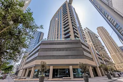 a large building in a city with tall buildings at Dunya Tower 1BR Heart of Dubai Downtown in Dubai