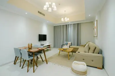a living room with a table and a dining room at Dunya Tower 1BR Heart of Dubai Downtown in Dubai