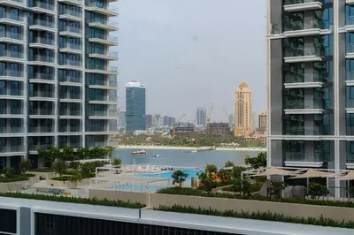 a view of a body of water between two buildings at Seaside Bliss Chic 1BR with Balcony, Pool & Gym in Dubai