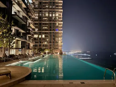 a large swimming pool in the middle of a building at Seaside Bliss Chic 1BR with Balcony, Pool & Gym in Dubai