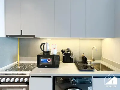 a kitchen counter with a coffee maker and a microwave at Modern Studio Retreat l MAG l Parking & WI-FI in Dubai
