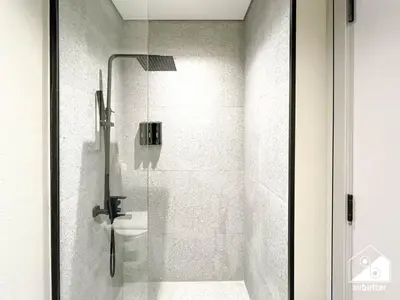 a bathroom with a glass shower with a toilet at Stylish Studio Living l MAG Meydan in Dubai