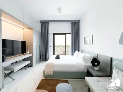 a hotel room with a bed and a tv at Stylish Studio Living l MAG Meydan in Dubai