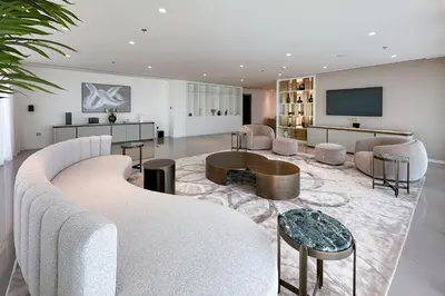 a living room with a couch and a tv at Luxe 2 bedroom Apartment full Sea and Palm Views in Dubai