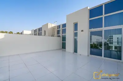 a large white building with a large window at Majestic 3BR Villa in DH2 by Deleguest in Dubai