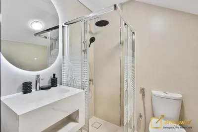 a white bathroom with a shower and a sink at Majestic 3BR Villa in DH2 by Deleguest in Dubai