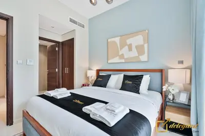 a bedroom with a large bed with two towels on it at Majestic 3BR Villa in DH2 by Deleguest in Dubai