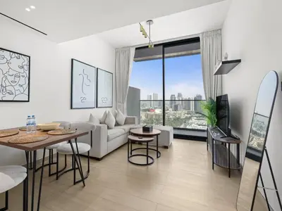 a living room with a couch and a table at Chic and Stylish 1 BDR in Binghatti corner - JVC in Dubai