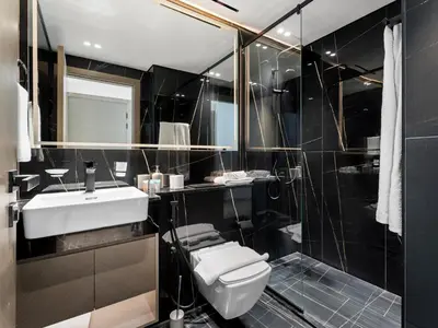 a bathroom with a white toilet and a sink at Chic and Stylish 1 BDR in Binghatti corner - JVC in Dubai
