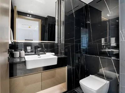 a bathroom with a white sink and a toilet at Chic and Stylish 1 BDR in Binghatti corner - JVC in Dubai