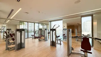 a gym with treadmills and exercise equipment in a building at Modern Creekside 1BR Near Dubai Mall & Downtown in Dubai