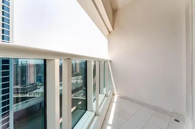 an apartment balcony with a view of a city at Stylish 1BR with Burj & Canal View in Dubai