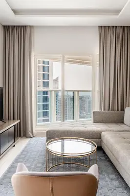a living room with a couch and a coffee table at Stylish 1BR with Burj & Canal View in Dubai
