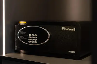 a black microwave oven sitting on top of a shelf at Luxury JLT Studio Renovated Lake View Metro in Dubai