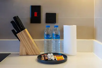 a counter with two bottles of water and a roll of paper towels at Luxury JLT Studio Renovated Lake View Metro in Dubai