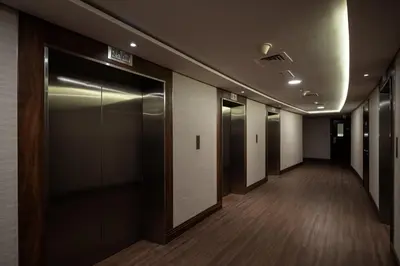 a corridor of an office building with elevator doors at Luxury JLT Studio Renovated Lake View Metro in Dubai