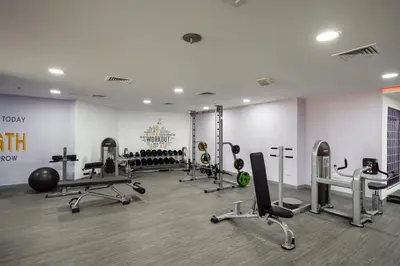 a gym with several treadmills and machines in a room at Luxury JLT Studio Renovated Lake View Metro in Dubai