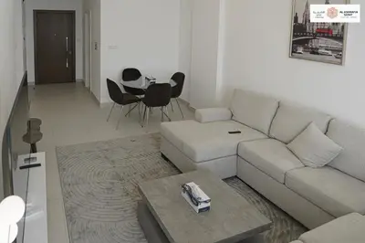 a living room with a couch and a table at Serenity 1 bdr with private garden in Dubai