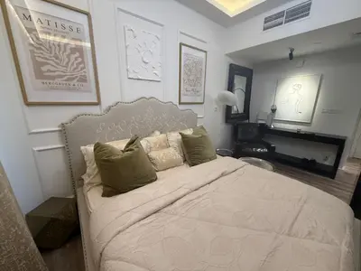 a bedroom with a large white bed with pillows at Lakeside D - Impz location in Dubai