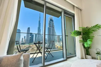 a room with large windows with a view of the city at BEST Burj Khalifa View 2br 3 beds in Dubai