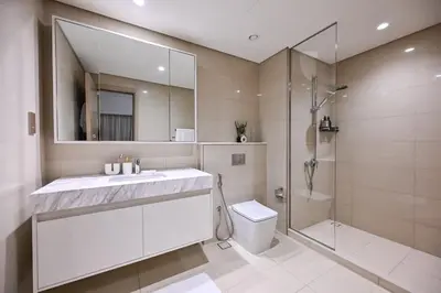 a bathroom with a sink and a shower and a toilet at BEST Burj Khalifa View 2br 3 beds in Dubai