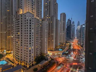 a city skyline with tall buildings and traffic at night at Superb 2BR Prime Locale between Dubai Marina JBR in Dubai