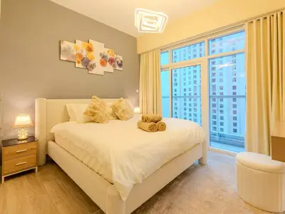 a bedroom with a bed with a teddy bear on it at Superb 2BR Prime Locale between Dubai Marina JBR in Dubai