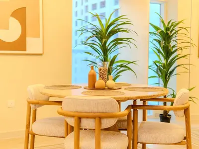 a dining room with a wooden table and chairs at Superb 2BR Prime Locale between Dubai Marina JBR in Dubai