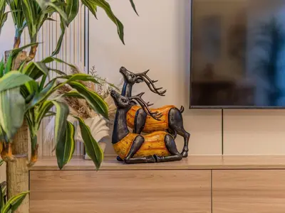 a statue of two deer sitting on top of a dresser at Superb 2BR Prime Locale between Dubai Marina JBR in Dubai