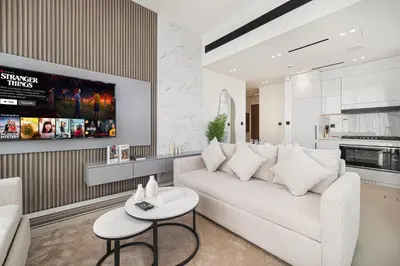 a living room with a couch and a table at Private Pool! Exceptional 2 Bedroom! Brand New Building with Pool and Gym! in Dubai