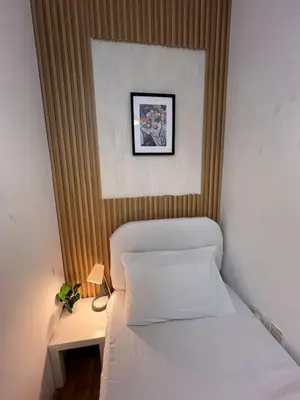a bedroom with a bed and a picture on the wall at Elite Single Suite Room Partition In Tecom in Dubai