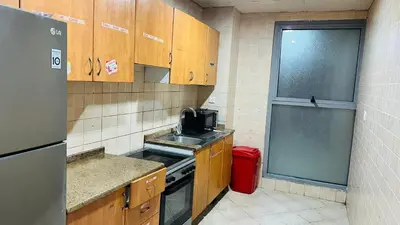 a small kitchen with a sink and a refrigerator at Deluxe solo Room In Barsha Heights Tecom in Dubai