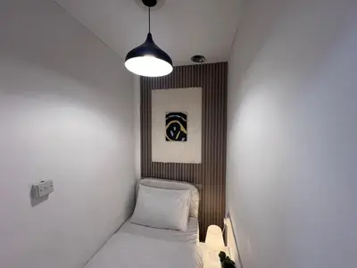 a small room with a bed and a light at Deluxe solo Room In Barsha Heights Tecom in Dubai