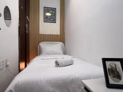 a hospital room with a bed with a towel on it at Solo space Partition room In Barsha Heights Tecom in Dubai