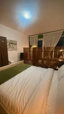 a large white bed in a bedroom with a window at Studio-Like Private Bedroom with Balcony & Private Washroom in JLT in Dubai