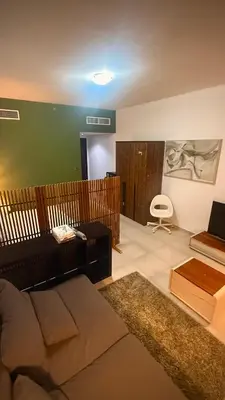 a living room with a couch and a table at Studio-Like Private Bedroom with Balcony & Private Washroom in JLT in Dubai