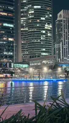 a view of a city at night with buildings at Studio-Like Private Bedroom with Balcony & Private Washroom in JLT in Dubai