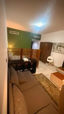 a living room with a couch and a table at Studio-Like Private Bedroom with Balcony & Private Washroom in JLT in Dubai