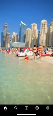a group of people playing in the water at a beach at The S Royal Marina Boutique Stay For Ladies And Families Only in Dubai