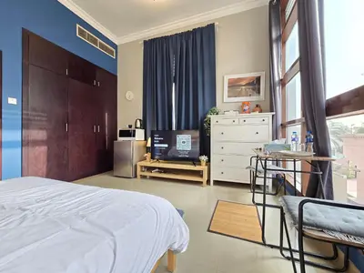a bedroom with a bed and a tv in it at Efficiancy studio 6mins walk to metro Near DWTC in Dubai