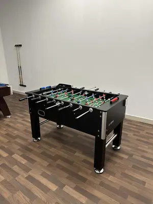 a black foosball table in a room at LUXE - Luxury Studio - Modern and Cozy in Dubai
