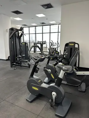 a gym with several tread machines in a room at LUXE - Luxury Studio - Modern and Cozy in Dubai