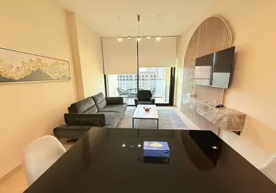 a living room with a table and a couch at Binghatti Crescent Cozy 2 BR in Dubai