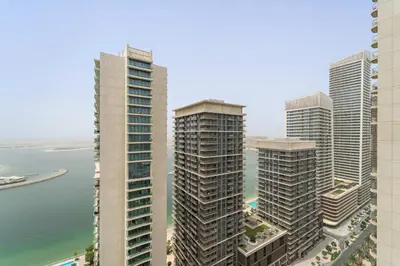 a group of tall buildings next to the water at Silkhaus Seaside Bliss 1BDR in Marina Vista in Dubai