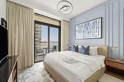 a bedroom with a large bed and a balcony at Silkhaus Seaside Bliss 1BDR in Marina Vista in Dubai