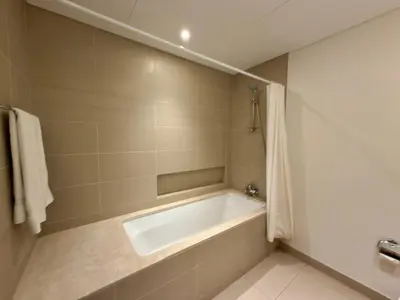 a bathroom with a bath tub in a room at Sunset Sea View at 5242 Emaar in Dubai