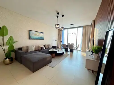 a living room with a couch and a table at Sunset Sea View at 5242 Emaar in Dubai